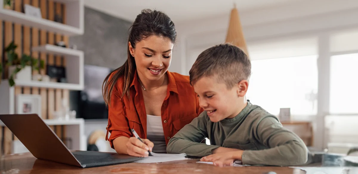 Mother and son attending to an online class