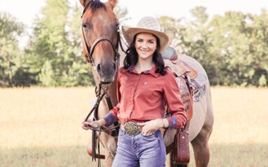 Photo of VSVA student Cydney Couch standing in front of one of her horses holding the reins.